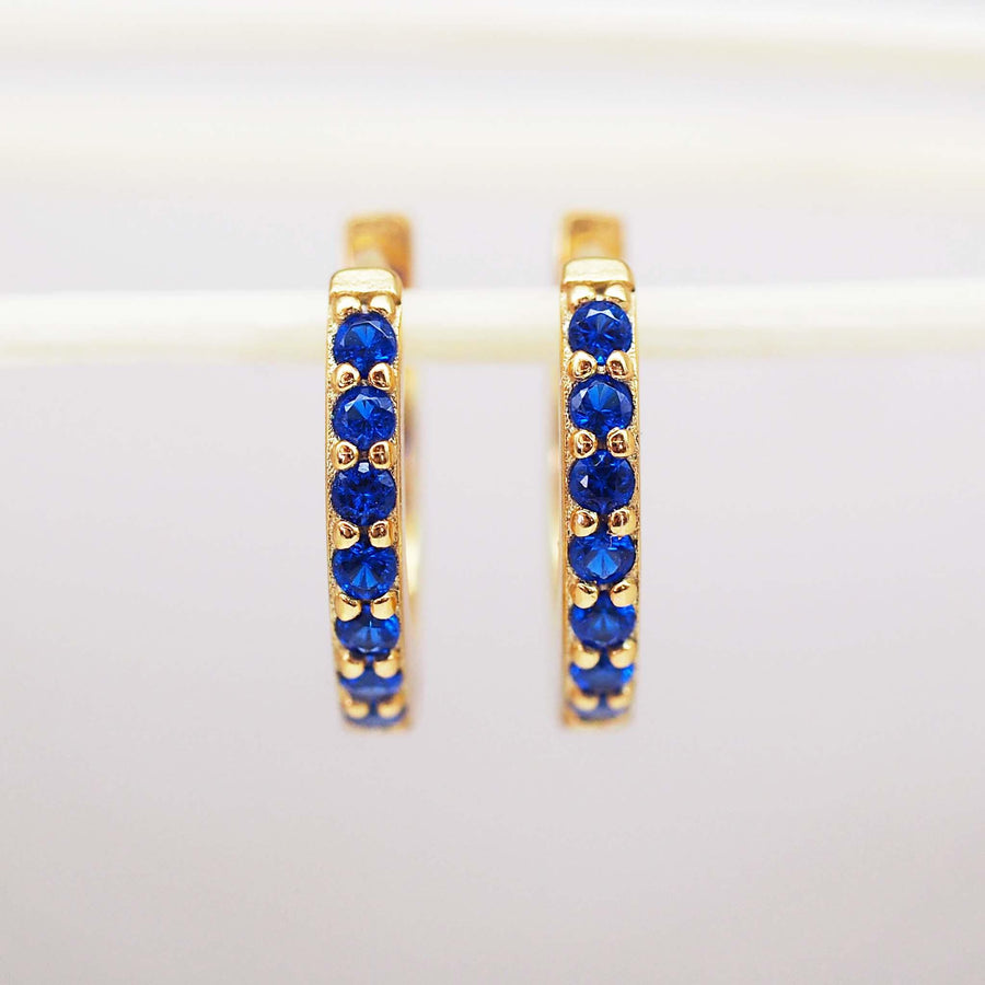 Gold huggie earrings with blue cubic zirconias - womens gold jewellery by Australian jewellery brand indie and harper