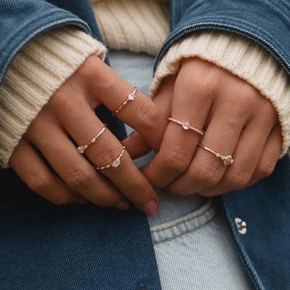 Woman wearing dainty gold and rose gold rings - rose gold jewellery 