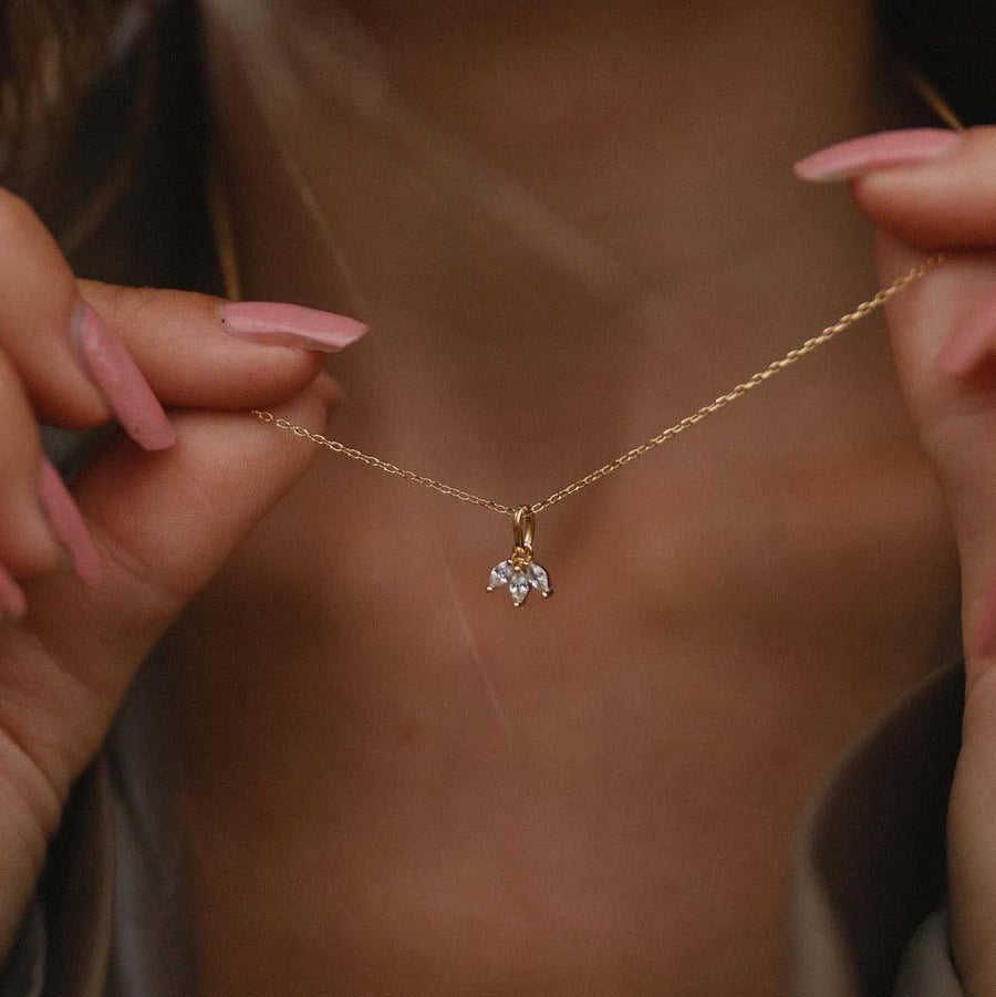 Woman holding and wearing her Sweet Dreams dainty Gold Necklace with three cubic zirconias - womens gold jewellery Australia by indie and harper