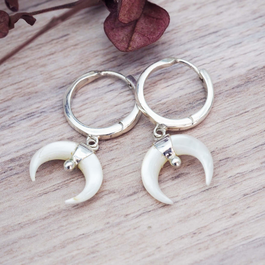 sterling silver earrings featuring half moon shape mother of pearl