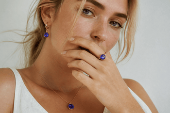Young woman wearing blue-violet tanzanite jewelry in natural light