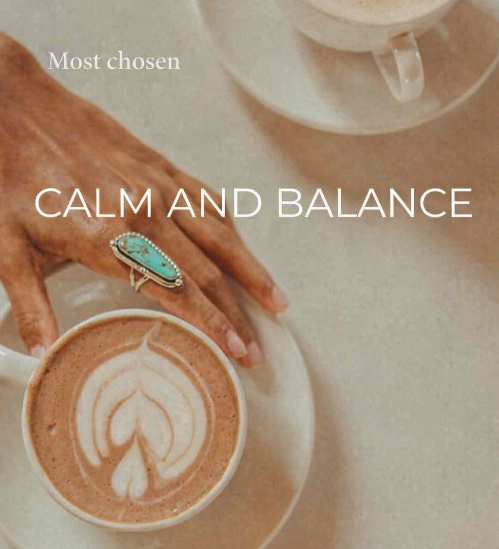 calm and balance jewellery collection showing a hand wearing a turquoise ring and with a cup of coffee