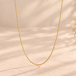 9k gold fine curb chain necklace hanging