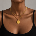 Woman in a black top wearing the gold waterproof zodiac medallion necklace