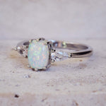 Silver ring with a large opal stone on a light background