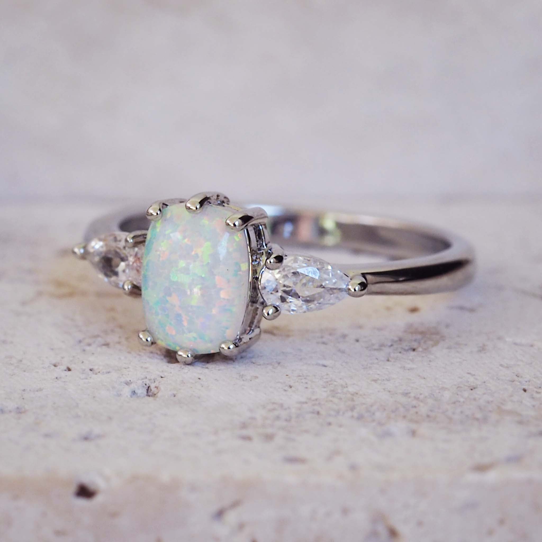 Silver ring with a large opal stone on a light background