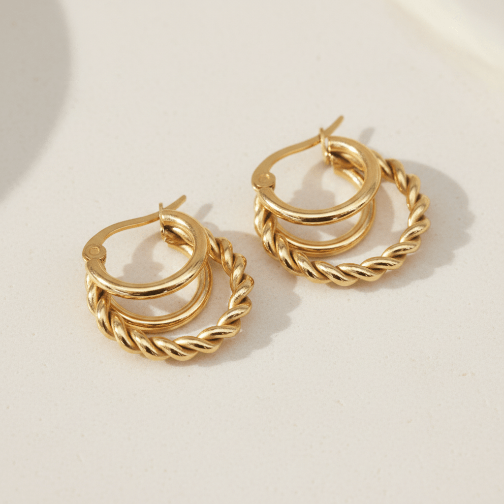 Gold hoop earrings on a light beige background