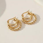 Pair of gold hoop earrings on a light background