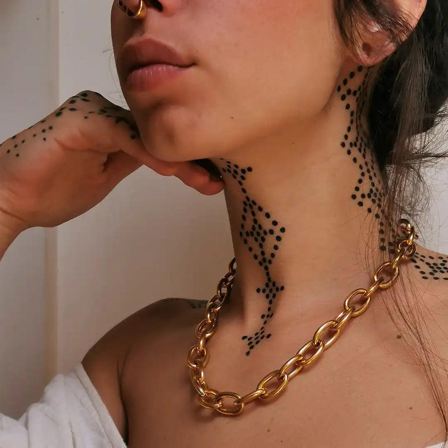 woman with neck tattoos wearing chunky gold Necklace - gold jewellery australia