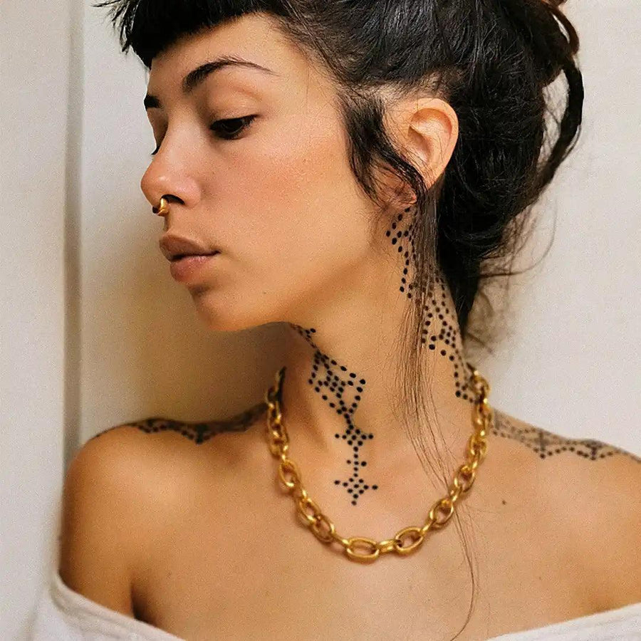 woman with black neck tattoos wearing chunky gold chain necklace - gold jewellery Australia 