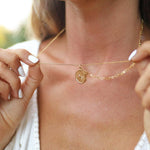 woman with white nails wearing gold layered necklace - gold waterproof jewellery by australian jewellery brands indie and harper