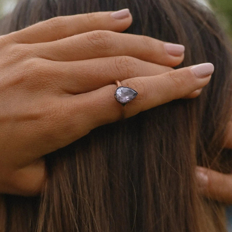 woman wearing copper ring with teardrop shaped amethyst stone - amethyst jewellery 