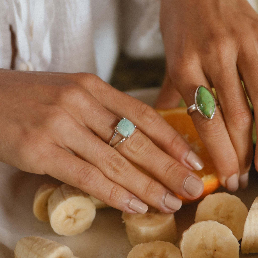 womans hands with bananas and oraange wearing boho jewellery
