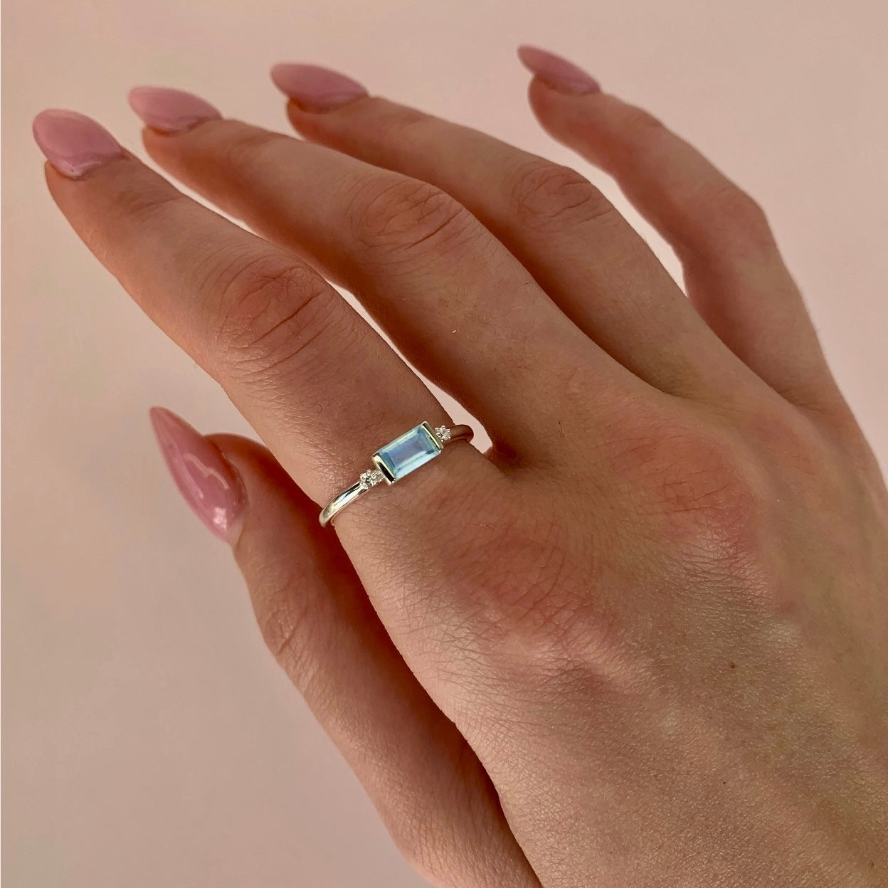 woman wearing sterling silver white topaz and aquamarine ring - indie and Harper 
