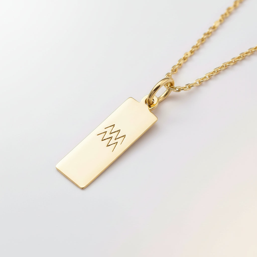 Gold aquarius zodiac pendant necklace on a soft white background
