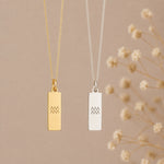 two Aquarius necklace in gold and silver, featuring rectangular bar pendants engraved with the minimalist Aquarius zodiac star sign line glyph symbols on fine curb chains.