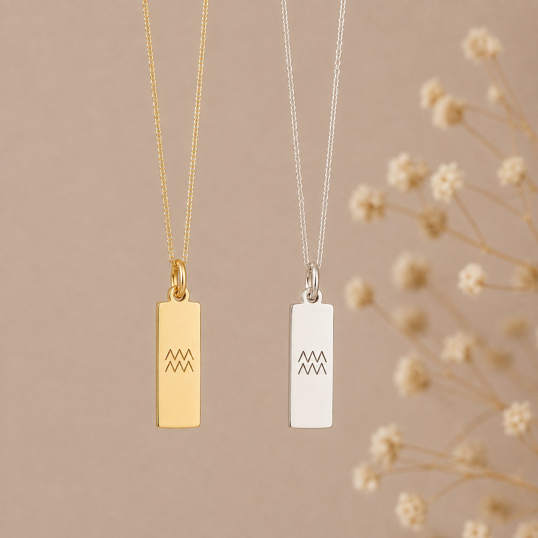 two Aquarius necklace in gold and silver, featuring rectangular bar pendants engraved with the minimalist Aquarius zodiac star sign line glyph symbols on fine curb chains.