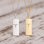 gold and silver fine chain necklaces with rectangle pendants engraved with aries line glyph