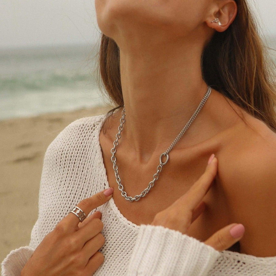 woman standing on beach wearing silver necklace - waterproof jewellery australia