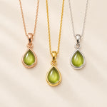 Three teardrop pendants with natural peridot stones in rose gold, yellow gold, and silver settings on delicate chains