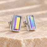 Aurore Boreale crystal baguette stud earrings in polished rhodium silver showing yellow and lilac colour flashes