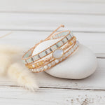 multi wrap natural moonstone gemstone beaded bracelet on a smooth white stone