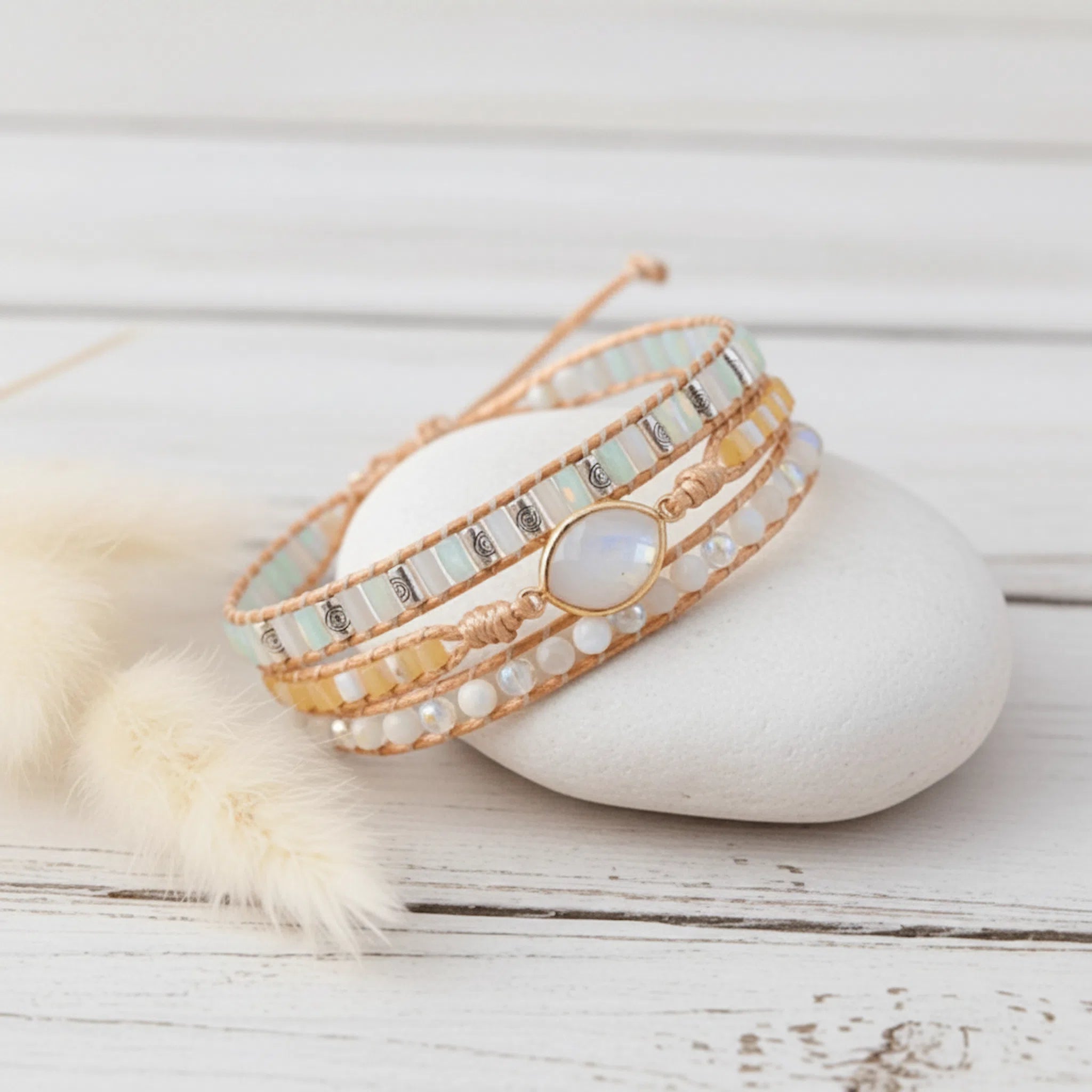 multi wrap natural moonstone gemstone beaded bracelet on a smooth white stone
