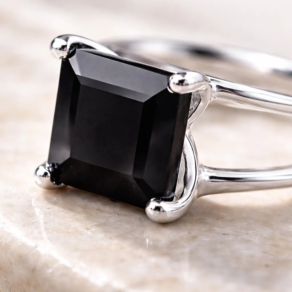 Sterling Silver ring with a black on yx gemstone on a light background