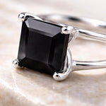  Sterling Silver ring with a black on yx gemstone on a light background