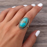 finger wearing a Sterling Silver Boho Ring with mohave turquoise gemstone 