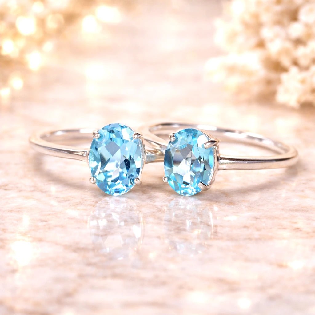 sterling Silver rings with two blue topaz  gemstones on a soft, blurred background
