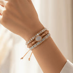 multi wrap boho style natural moonstone gemstone beaded bracelet being worn on a womans wrist with soft lighting