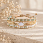 boho style wrap bracelet with multiple beads and moonstone on a stone surface