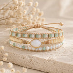 boho style wrap bracelet with multiple beads and moonstone on a stone surface