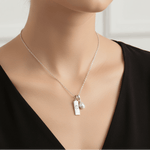 Sterling Silver Necklace with a June Birthstone Pearl pendant and a cancer zodiac star sign pendant being worn
