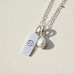 Sterling Silver Necklace with a June Birthstone Pearl pendant and a cancer zodiac star sign pendant