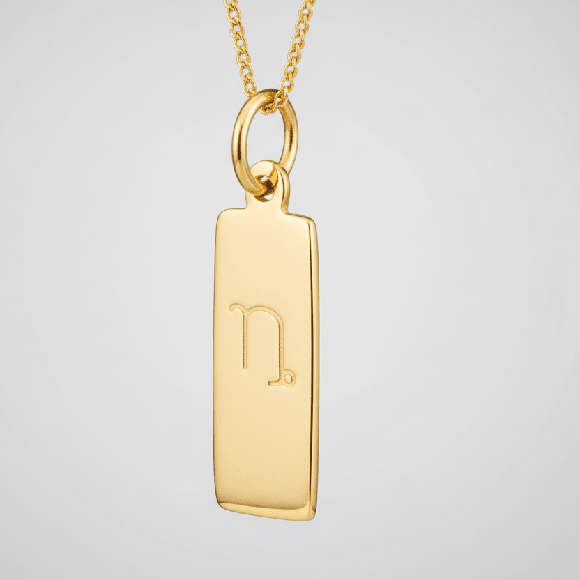 Capricorn zodiac necklace in 9k gold plated sterling silver against a white background 