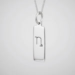 Capricorn zodiac necklace in sterling silver against a white background
