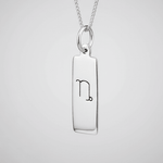 Capricorn zodiac necklace in sterling silver against a white background