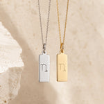 sterling silver and gold fine chain necklaces with a rectangle pendants engraved with the capricorn zodiac line glyph symbol hangin