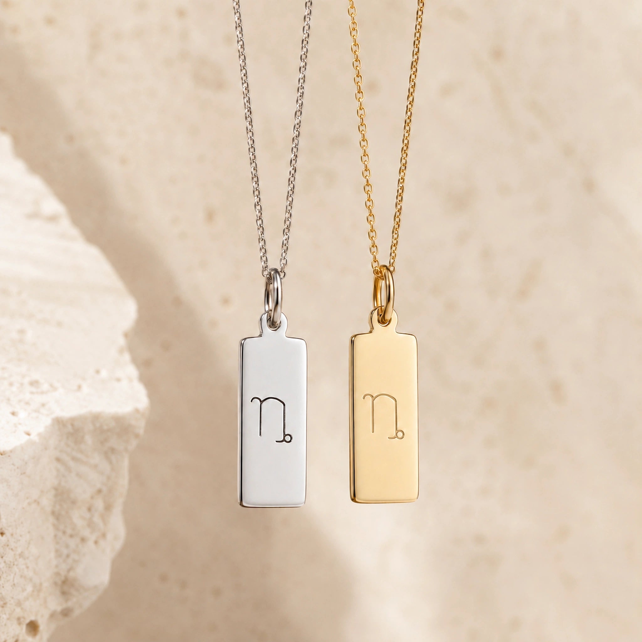 capricorn necklaces - sterling silver and gold fine chain necklaces with a rectangle pendants engraved with the capricorn zodiac line glyph symbol hangin
