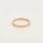 rose gold band stacker ring on a grey surface, as one of the three rings in the rose gold multi ring set