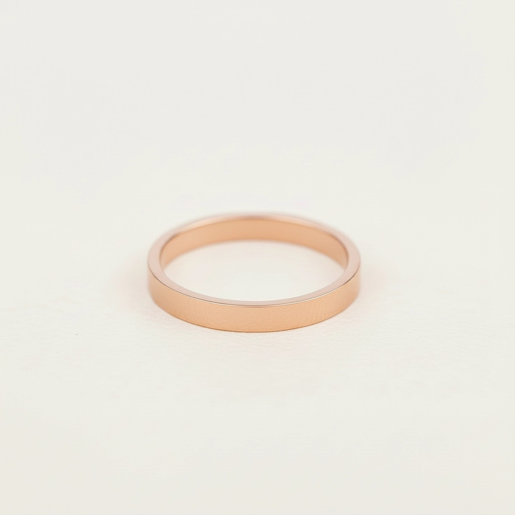rose gold band stacker ring on a grey surface, as one of the three rings in the rose gold multi ring set