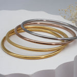 Gold, brushed gold, rose gold and silver stainless steel bangle bracelets - waterproof jewellery by indie and harper