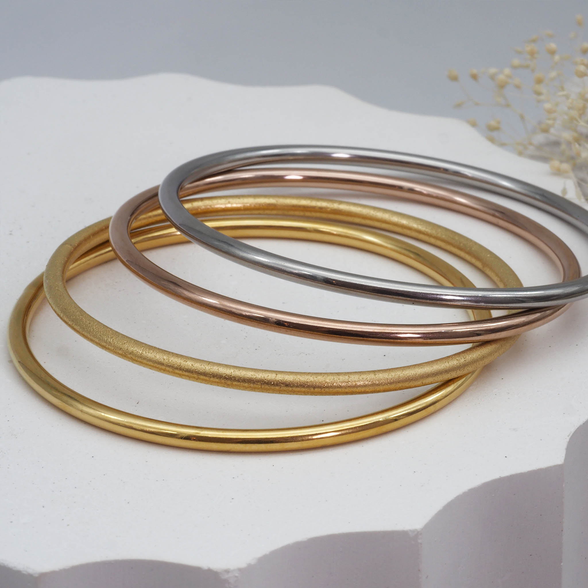 Gold, brushed gold, rose gold and silver stainless steel bangle bracelets - waterproof jewellery by indie and harper