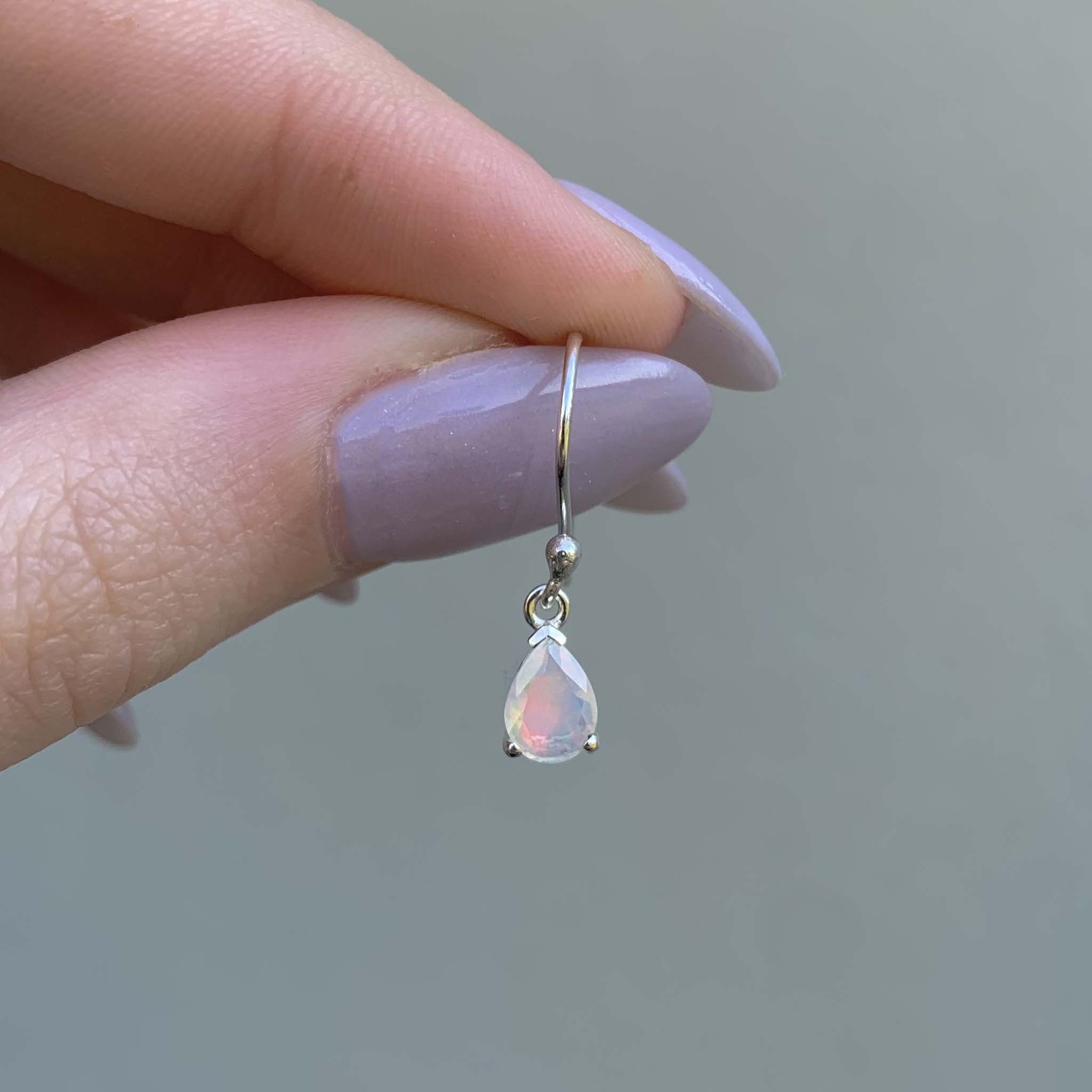 classic opal earrings being held - dainty opal jewellery by Australian jewellery brands indie and harper