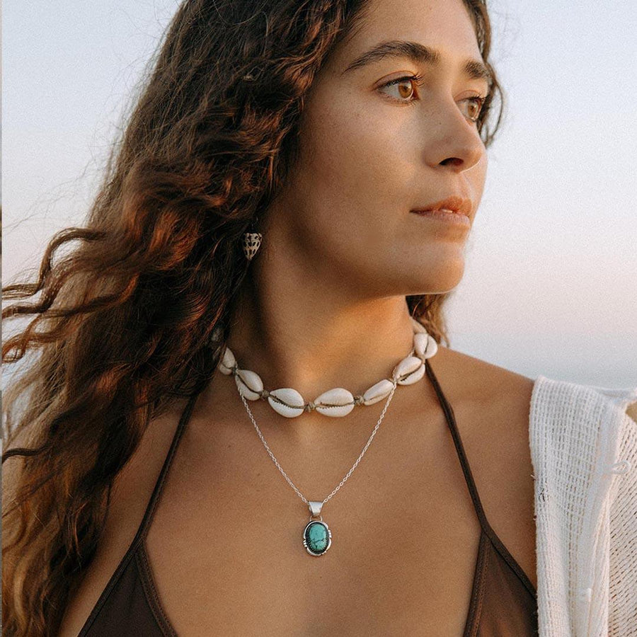 Woman wearing cowrie sea shell necklace - Australian jewellery brand 
