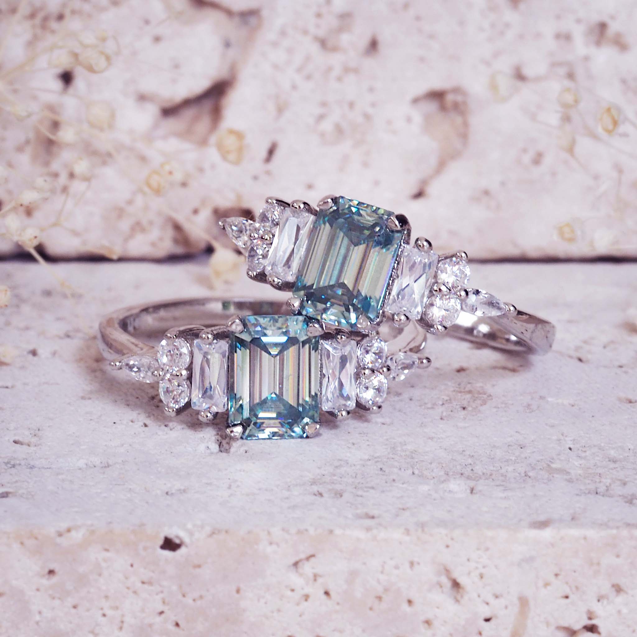 Pair of diamond-studded rings on a textured surface