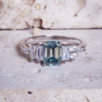 Silver ring with a blue gemstone on a textured surface