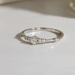 Silver ring with small cubic zirconias on a light surface